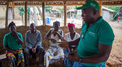 Anthony Vandy of Concern talking to community members in the village of Dokoizia in Lofa County, Liberia. Photograph taken by: Kieran McConvillle/Concern Worldwide.