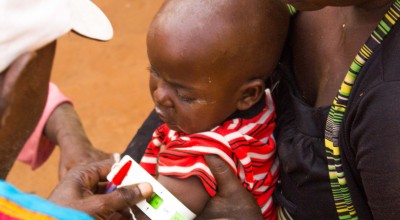Elisa and her daughter Josephine being screened by a community health worker in Cibitoke. Photo: Irenee Nduwayezu/Concern Worldwide.