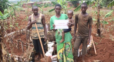 Odette Kanziza, along with family members, stands on front of her kitchen garden which was constructed with thanks to a generous $100 (€95) public donation. Photo: Concern Worldwide.