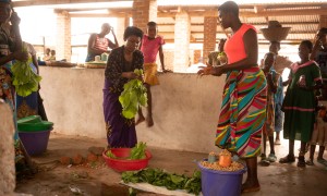 Rose and Stone selling freshly picked produce from the family farm in Nsanje, Malawi. Stone and Rose are participants in the Graduation Programme / Umodzi project. Photo: Chris Gagnon/Concern Worldwide.
