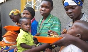 Children are fed as part of a community-based management of acute malnutrition (CMAM) programme held at a community health center in the southern Rwandan village of Gisagara. Photo: Cheney Orr / Concern Worldwide.