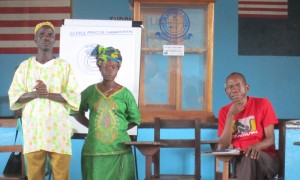 William Zoe, Martha Waaloe, community change makers and Harry Johnson, Concern staff member, at an engaging men and women in equality workshop, Liberia, 2013. Photo: Bernadette Crawford/ Concern Worldwide.