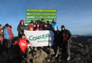 Team Concern holding banner at Uhuru Peak